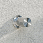 Nero Pure brushed nickel shower mixer on textured wall, with round wall plate and cylindrical progressive handle