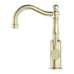 Nero York basin mixer tap in aged brass, with hook spout and metal lever handle, on white background