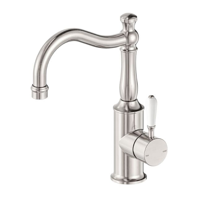 Nero York basin mixer tap in brushed nickel with hook spout and white porcelain lever, side view on white background