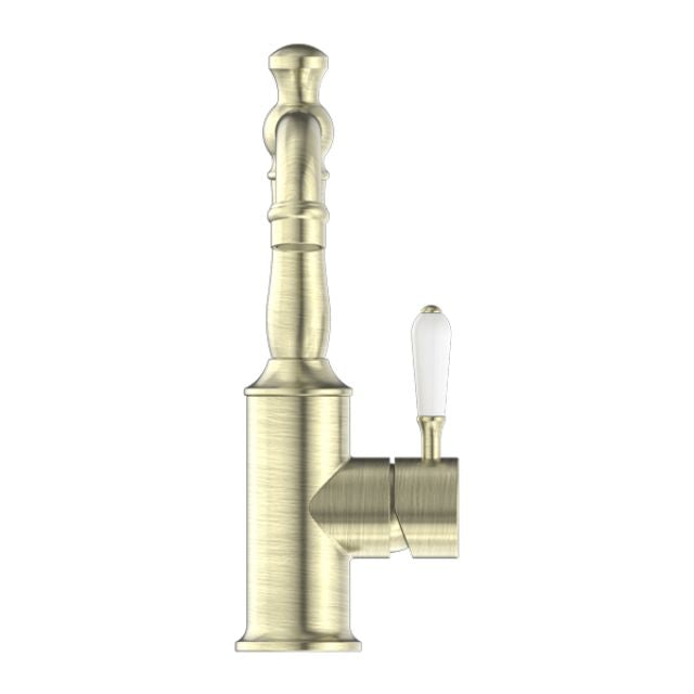 Nero York basin mixer tap in aged brass with white porcelain lever, side view, on white background