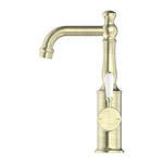 Nero York basin mixer in aged brass with white porcelain lever, front view on white background