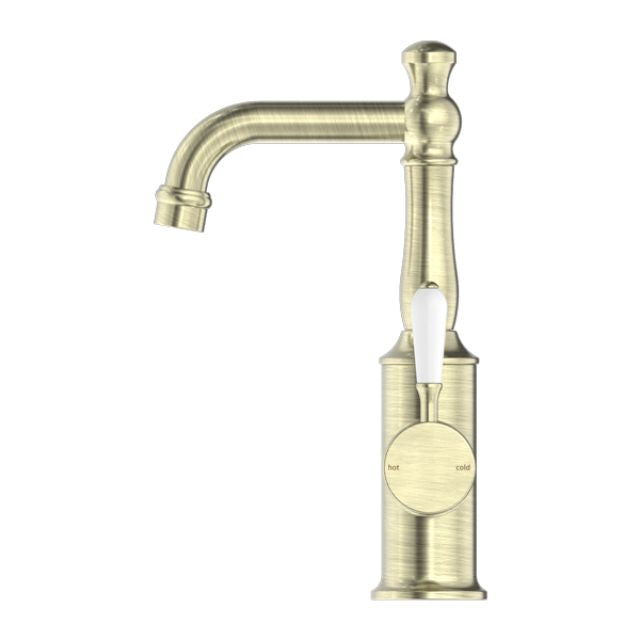 Nero York basin mixer in aged brass with white porcelain lever, front view on white background
