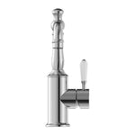 Nero York chrome basin mixer with white porcelain lever, side view on white background