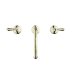 Nero York 3-piece basin tap set in aged brass, with central spout and two metal lever handles on white background