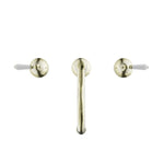 Nero York three-piece basin set in aged brass with white porcelain lever handles, front view on white background