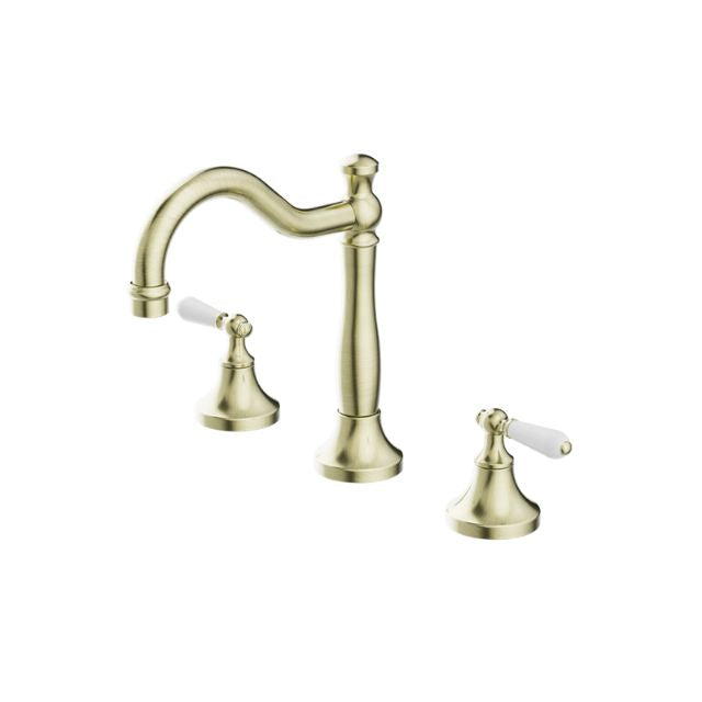 Nero York aged brass 3 piece basin tap set with white porcelain lever handles on a white background