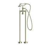 Nero York freestanding bath set in aged brass with white porcelain hand shower and floor-mounted taps
