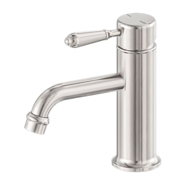 Nero York straight basin mixer tap in brushed nickel with metal lever, side view on white background
