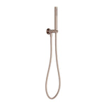 Nero Zen wall-mounted hand shower on bracket in brushed bronze with hose, shown on a white background