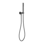 Nero Zen wall-mounted hand shower on bracket in graphite, with slim hose and round holder against a white background