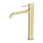 Nero Zen tall basin mixer in brushed gold, with cylindrical body and curved spout, front view on white background