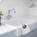 Phoenix Nostalgia twin handle sink mixer in chrome and white, with shepherds crook spout on a white farmhouse sink