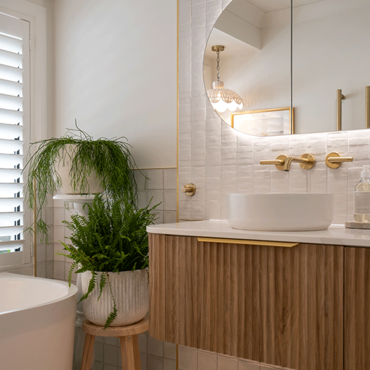 Phoenix Vivid Slimline Plus brushed gold wall top assemblies in a modern bathroom vanity setting