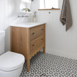 Phoenix Cromford wall-mounted basin/bath tap set in brushed nickel, shown installed above a vanity in a bathroom