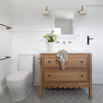 Phoenix Cromford chrome 3 piece wall basin/bath tap set on white bathroom wall above timber vanity, front view