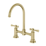 Phoenix Cromford exposed sink set in brushed gold with dual lever handles and swivel gooseneck spout, front view.