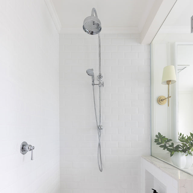 Phoenix Cromford twin rail shower in chrome with overhead rose and handpiece in a white tiled bathroom