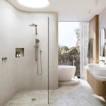 Phoenix Lexi MKII brushed nickel shower mixer and hand shower set in a modern walk-in bathroom, with wall spout and vanity taps visible