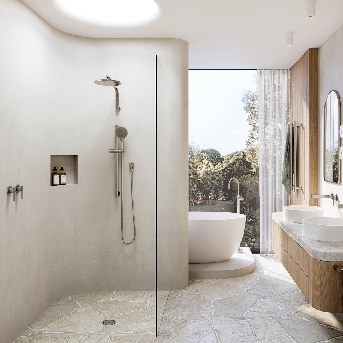 Phoenix Lexi MKII brushed nickel shower mixer and hand shower set in a modern walk-in bathroom, with wall spout and vanity taps visible