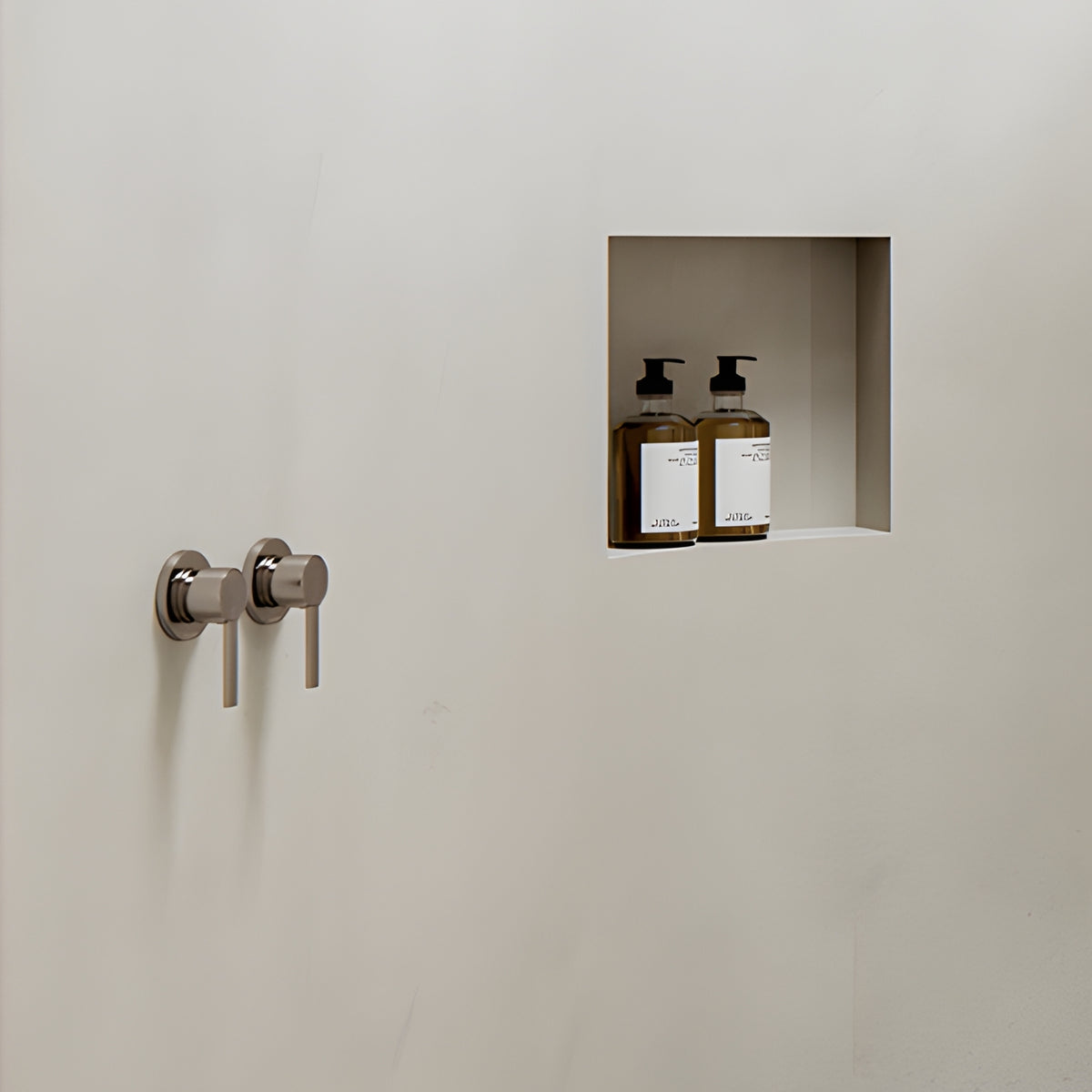 Phoenix Lexi MKII wall-mounted shower mixer in brushed nickel, shown on a bathroom wall with recessed shelf