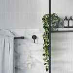 Phoenix Lexi MKII wall-mounted shower mixer in matte black, shown in a modern bathroom vanity setting