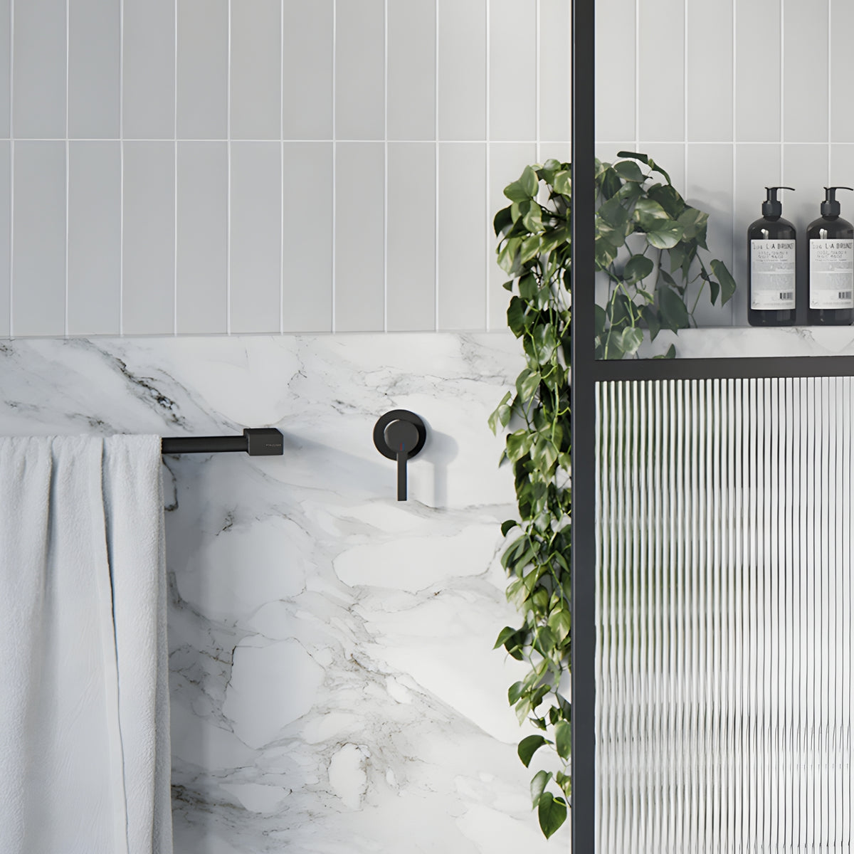 Phoenix Lexi MKII wall-mounted shower mixer in matte black, shown in a modern bathroom vanity setting