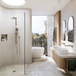 Brushed nickel wall-mounted basin mixer set in a modern bathroom beside twin vessel basins and shower area