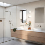 Modern bathroom with Phoenix Mekko brushed nickel wall mixer, shower fittings and twin vanity taps in a light tiled interior