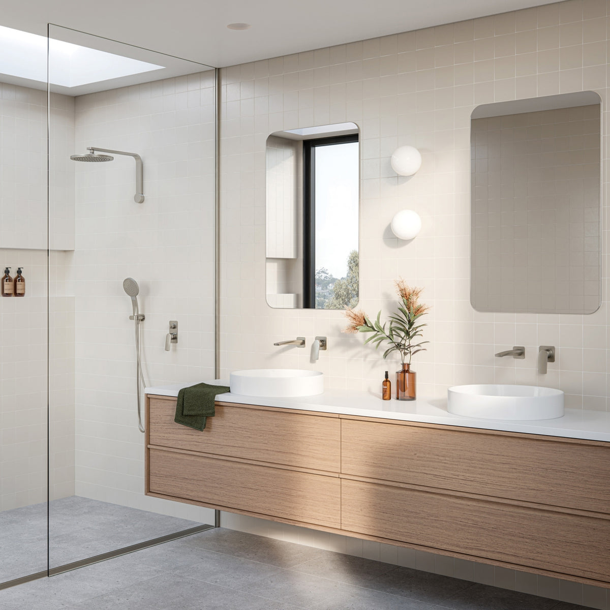 Modern bathroom with Phoenix Mekko brushed nickel wall mixer, shower fittings and twin vanity taps in a light tiled interior