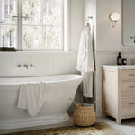 Phoenix Nostalgia brushed nickel wall-mounted basin/bath tap set with shepherds crook spout above a freestanding bath