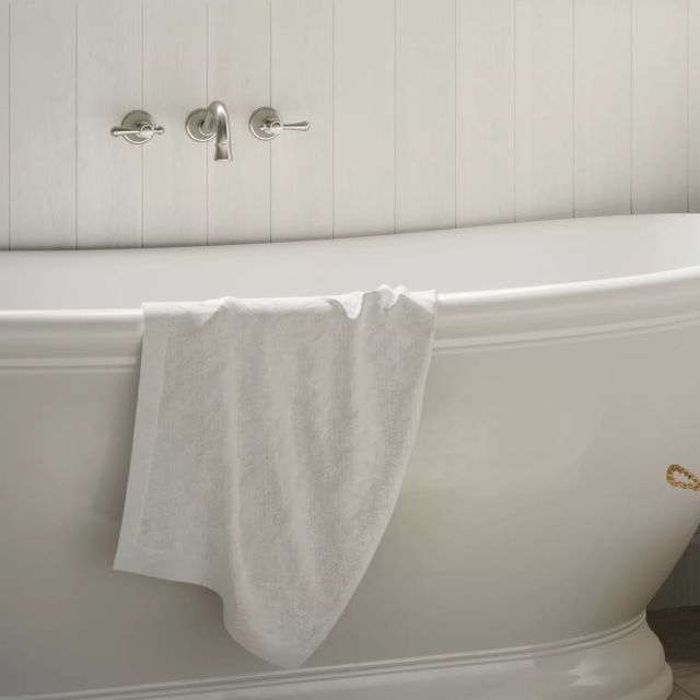 Phoenix Nostalgia brushed nickel wall basin/bath set with lever handles above a white freestanding bath