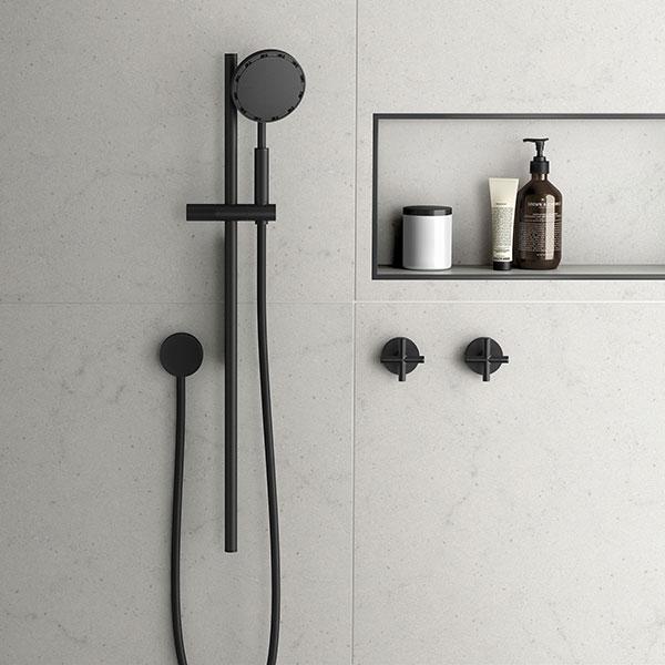 Phoenix NX IKO matte black rail shower with round handpiece and wall-mounted holder in a modern bathroom setting