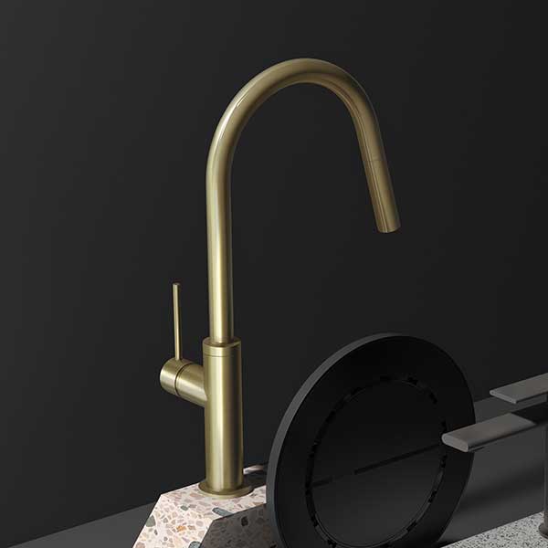 Phoenix Vivid Slimline pull out sink mixer in brushed gold, shown in angled view with curved spout and slim lever handle