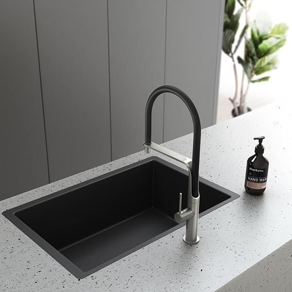 Phoenix Vido pull-out kitchen sink mixer in chrome with black hose over a black undermount sink and speckled benchtop