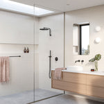 Phoenix Vivid 300mm round shower rose in chrome, shown installed in a modern bathroom shower setting