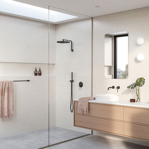 Phoenix Vivid 300mm round shower rose in chrome, shown installed in a modern bathroom shower setting