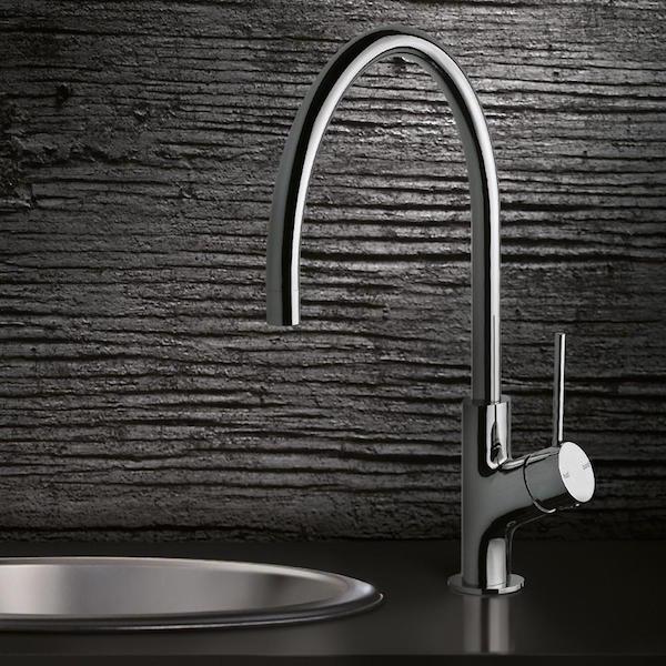 Phoenix Vivid Slimline chrome gooseneck sink mixer with oval base, shown mounted beside a round sink basin