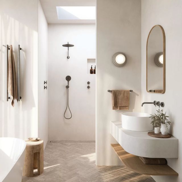 Phoenix Vivid Slimline Plus wall top assemblies in brushed carbon, shown on a modern bathroom wall beside a basin and mirror