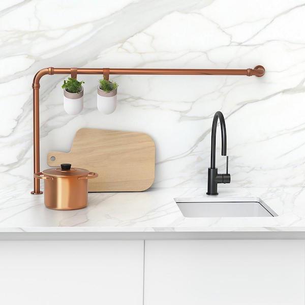 Phoenix Vivid Slimline matte black gooseneck sink mixer with side lever on a white kitchen benchtop