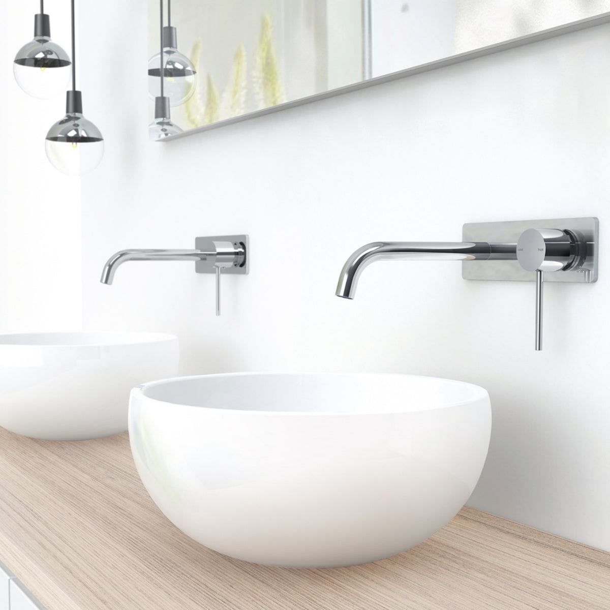 Phoenix Vivid Slimline wall basin mixer set in chrome, shown above a white vessel basin in a modern bathroom setting