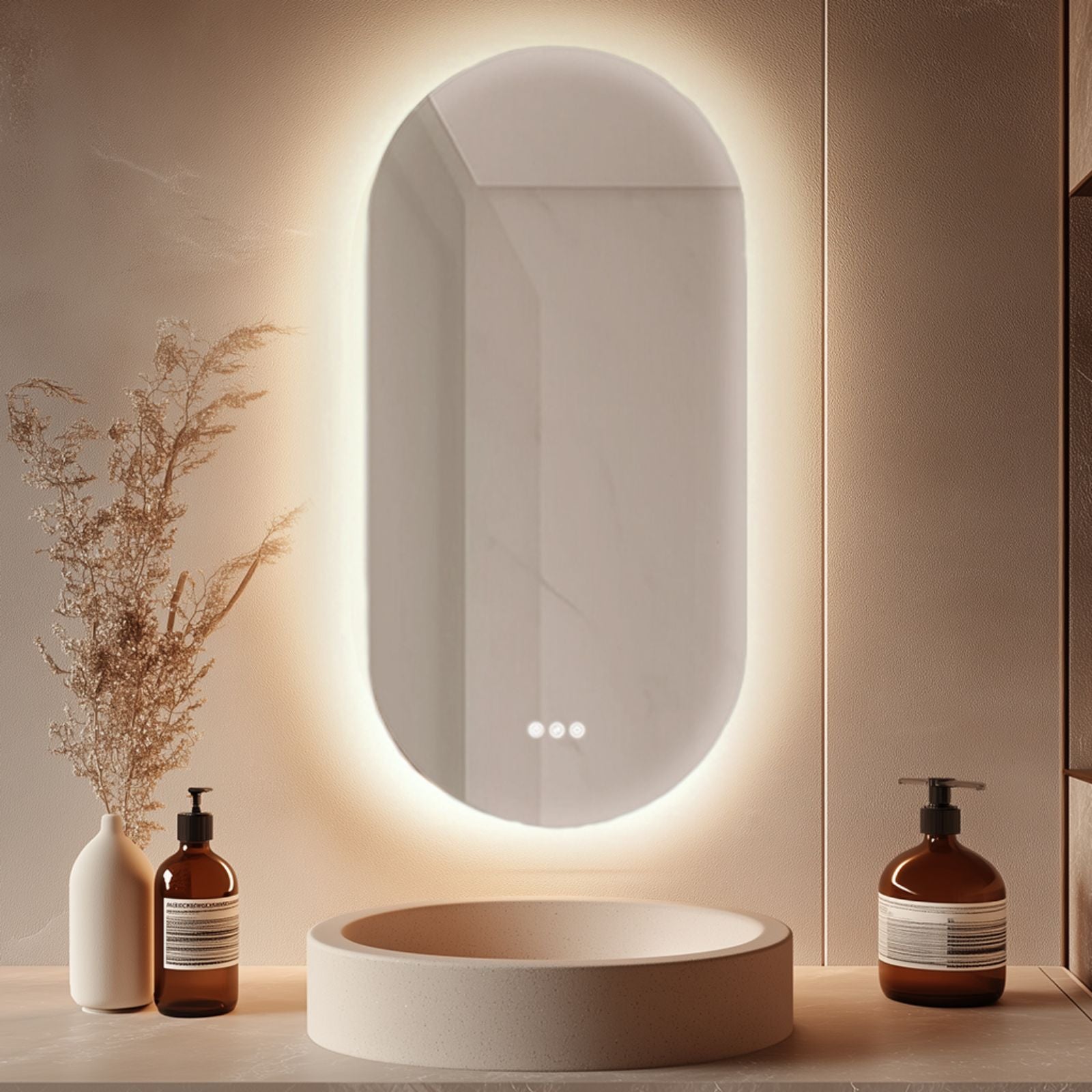 Radiant Kapsel frameless oval LED mirror with warm backlighting, shown above a bathroom vanity sink