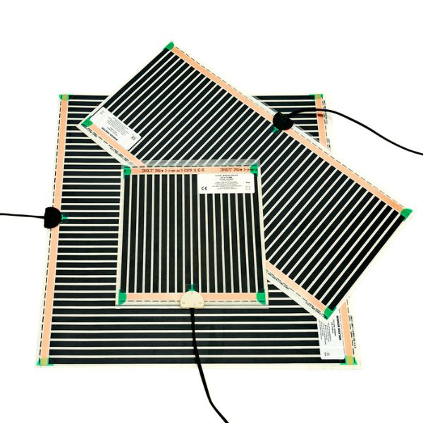 Radiant mirror demister pads in black, shown stacked on a white background with wired connector blocks and self-adhesive backing.