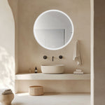 Radiant Olek round LED mirror with white edge lighting in a beige bathroom vanity setting