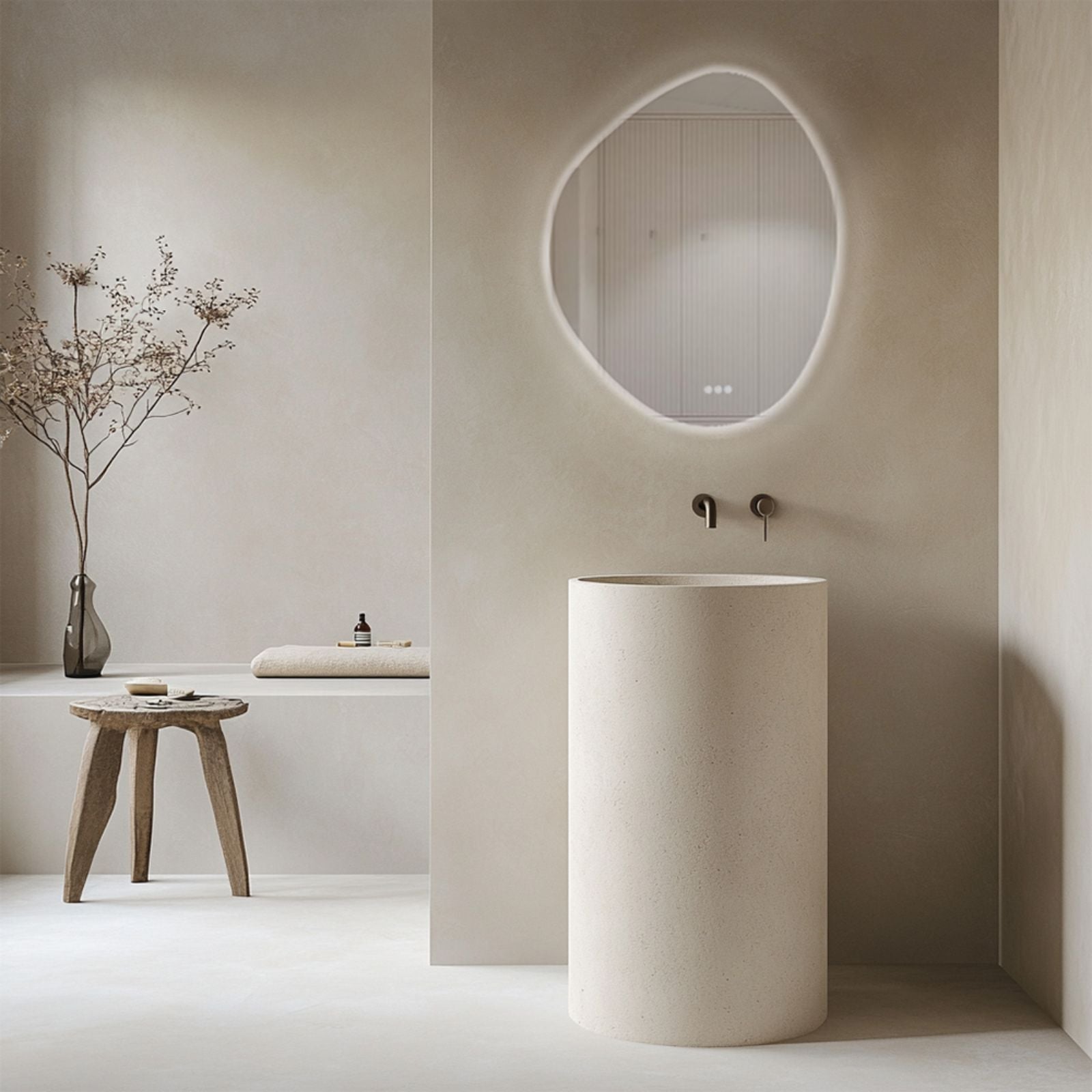 Radiant Pebl frameless round LED mirror with halo light, shown above a minimal bathroom vanity in warm beige tones