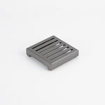 Radiant square slotted floor grate in gun metal grey, 100mm x 100mm, stainless steel, shown on white background