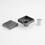 Radiant square slotted floor grate in gun metal grey, with waste body and basket insert shown on white background