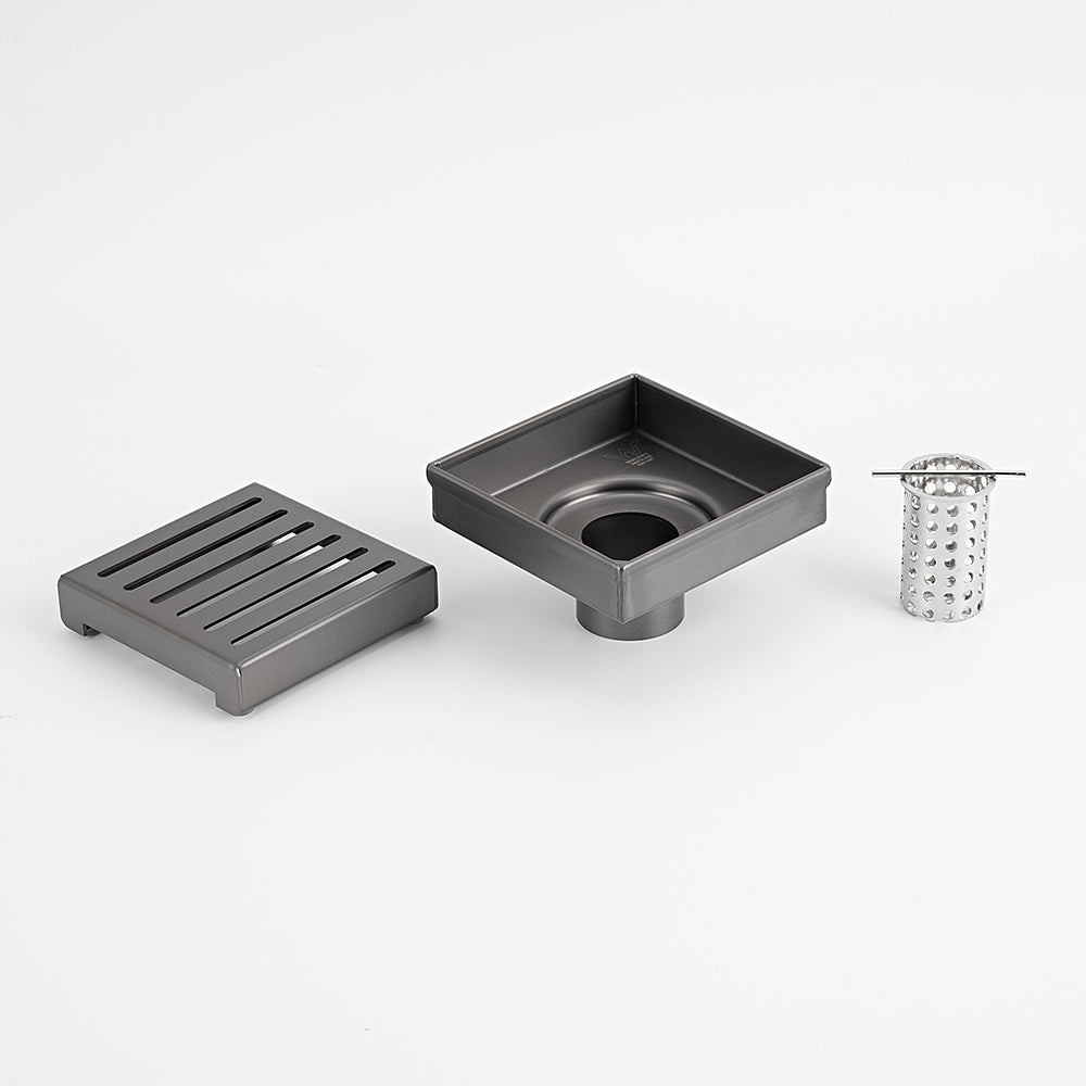 Radiant square slotted floor grate in gun metal grey, with waste body and basket insert shown on white background