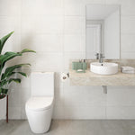 White round above-counter basin on a stone vanity in a modern bathroom, with chrome tap and mirror above