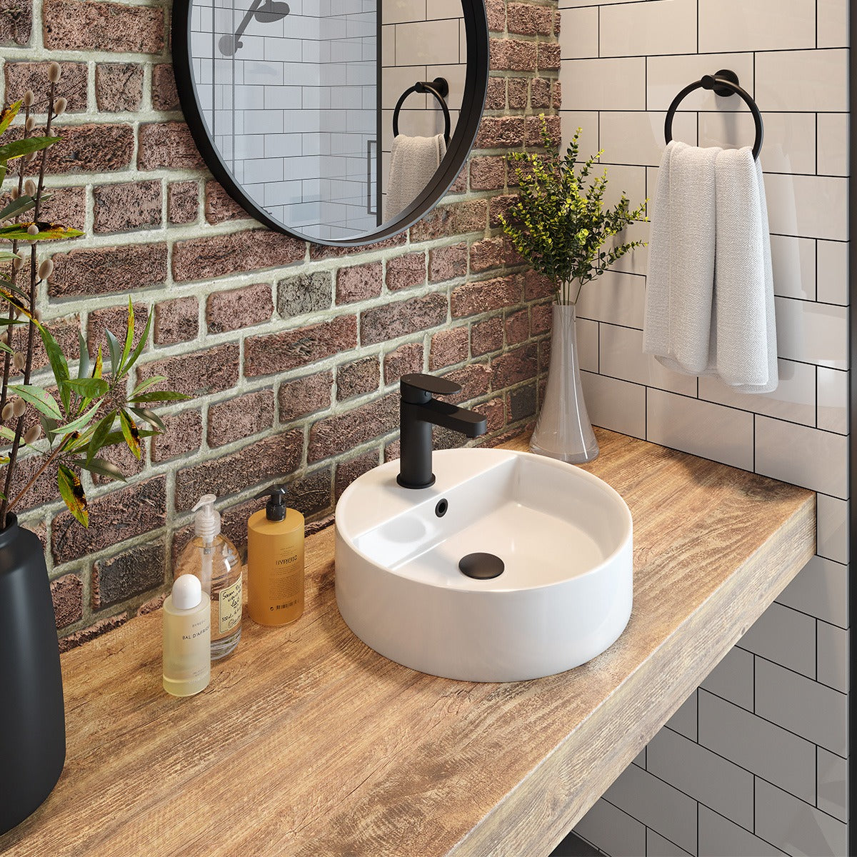 Round white above-counter basin with black mixer tap on a timber vanity in a bathroom setting