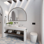 Raymor white wall faced rimless toilet with slim seat in a modern bathroom beside vanity and mirror